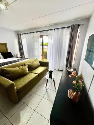 a living room with a couch and a table at Protea Apartment Midrand in Midrand