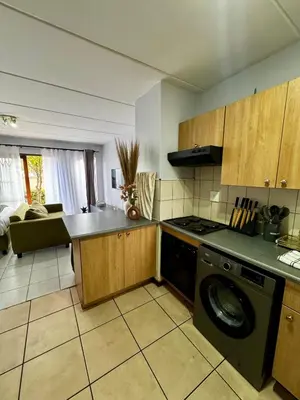 a kitchen with a stove and a dishwasher at Protea Apartment Midrand in Midrand
