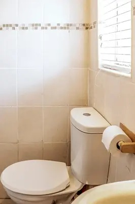 a bathroom with a toilet and a sink at Refresh On Wolseley in Secunda