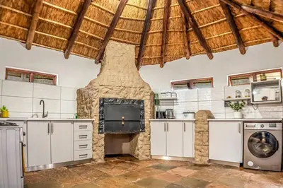 a kitchen with a stone oven and a stove at Refresh On Wolseley in Secunda