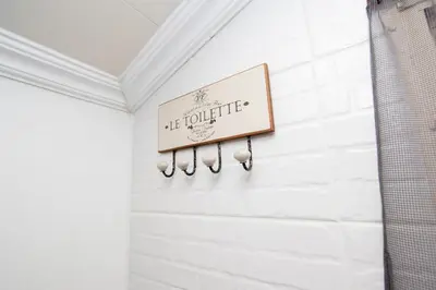 a sign on the wall of a bathroom at Farmstay at Rehoboth in Benoni