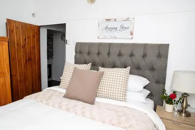 a bedroom with a large bed with pillows at Farmstay at Rehoboth in Benoni