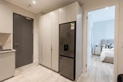 a kitchen with a door leading to a bedroom at 132 Menlyn Maine in Pretoria