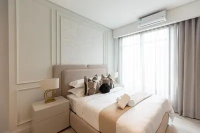 a bedroom with a large white bed with a window at 132 Menlyn Maine in Pretoria