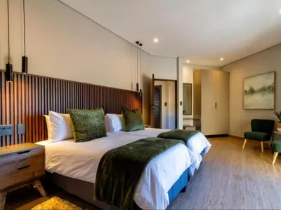 a bedroom with a large bed with a wooden headboard at Tenkudu Bush Lodge in Hammanskraal