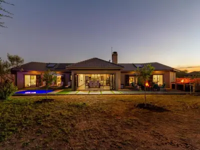 a large house with a yard in front of it at Tenkudu Bush Lodge in Hammanskraal