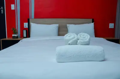 a bedroom with a bed with towels on it at No 419 Guest House in Midrand