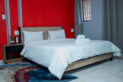 a bedroom with a large bed with a stuffed animal on it at No 419 Guest House in Midrand
