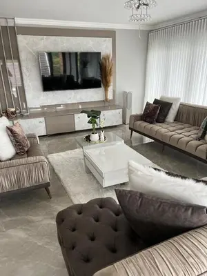 a living room with two couches and a tv at Alimu villa in Nelspruit