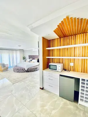 a living room with a bedroom and a bed at Alimu villa in Nelspruit