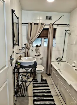 a bathroom with a sink and a toilet and a tub at Be Our Guest Near OR Tambo International Airport 2 in Boksburg
