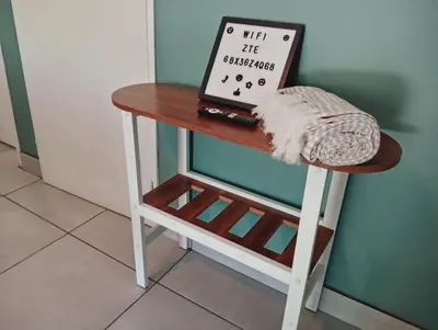 a small table with a laptop on top of it at Be Our Guest Near OR Tambo International Airport 2 in Boksburg