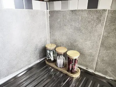a group of three jars sitting on a shelf in a room at Akwaaba Fie Guesthouse in Lebowakgomo