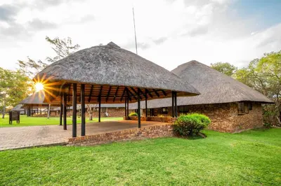 a hut with a thatched roof on the grass at Kruger Park Lodge Unit 526 in Hazyview