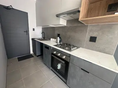 a kitchen with a stove and a counter top at Business trip or Fun with the Family - you decide! in Pretoria