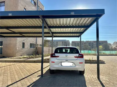 a white car parked under a blue canopy at Business trip or Fun with the Family - you decide! in Pretoria
