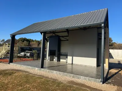 a building with a metal roof and a patio at Business trip or Fun with the Family - you decide! in Pretoria