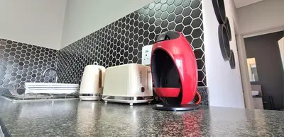 a red appliance sitting on top of a kitchen counter at Convenient Corner of GreenValley estate in Nelspruit