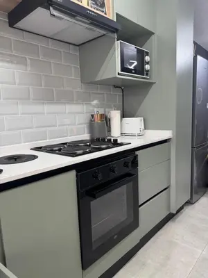 a kitchen with a black and white stove top oven at Closer to CBD by UrbanCove in Nelspruit