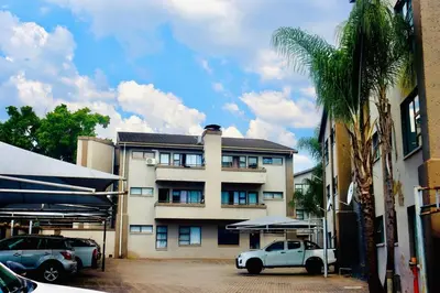 a white truck parked in front of a building at Closer to CBD by UrbanCove in Nelspruit