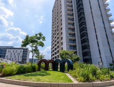a sculpture in front of a tall building at Brown, Warm and Cozy, Menlyn Maine Residences 926 in Pretoria