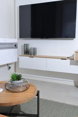a living room with a tv and a coffee table at Green Serene Studio, Menlyn Maine Residences 826 in Pretoria