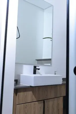 a bathroom with a white sink and a mirror at Green Serene Studio, Menlyn Maine Residences 826 in Pretoria