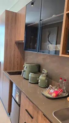 a kitchen counter with two green pots on it at Green Serene Studio, Menlyn Maine Residences 826 in Pretoria