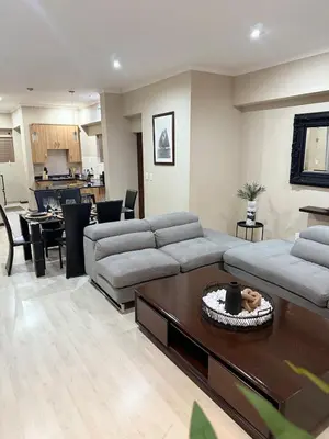 a living room with a couch and a table at Stylish Riverside Home with Pool, Braai & Wi-Fi in Nelspruit