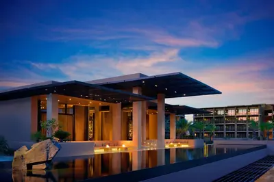 a building with a pool in front of a building at luucole the palm in Thohoyandou