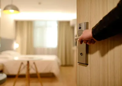 a person opening a door to a hotel room at luucole the palm in Thohoyandou