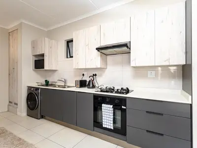 a kitchen with a stove and a dishwasher at The Sweet Serenity Suite in Midrand