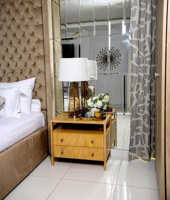 a bedroom with a bed and a table with a lamp at Beyond Borders Guest House in Polokwane