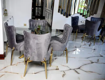 a dining room with a glass table and chairs at Beyond Borders Guest House in Polokwane