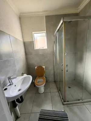 a bathroom with a toilet and a sink and a shower at Calm Corner in Pretoria