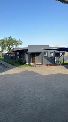 a house with a driveway in front of it at TLS Cottages