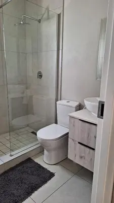 a bathroom with a shower and a toilet and a sink at The Perfect Luxury Space at 93 on new in Midrand