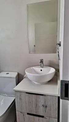 a bathroom with a sink and a toilet and a mirror at The Perfect Luxury Space at 93 on new in Midrand