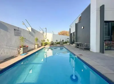 a swimming pool in front of a building at The Perfect Luxury Space at 93 on new in Midrand