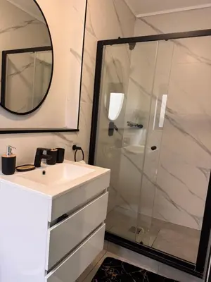 a bathroom with a shower and a sink and a mirror at Staycation At Munyaka Estate in Midrand