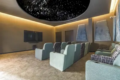 a waiting room with chairs and a flat screen tv at Staycation At Munyaka Estate in Midrand