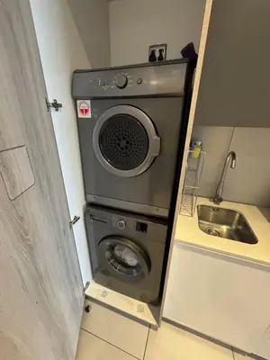 a washing machine in a kitchen with a sink at Menlyn Maine Residences 811 in Pretoria