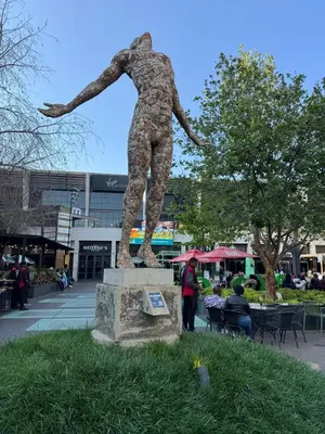 a statue of a person standing in the grass at Menlyn Maine Residences 811 in Pretoria