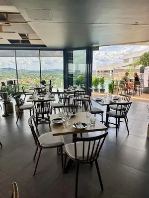 a restaurant with tables and chairs with a view at Menlyn Maine Residences 811 in Pretoria