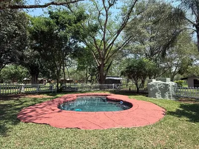 a small pond in the middle of a yard at Elephant 1 Chalet Hippo Waterfront Lodge in Nelspruit