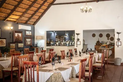 a large dining room with tables and chairs at Karongwe- Shiduli Safari Lodge in Hoedspruit