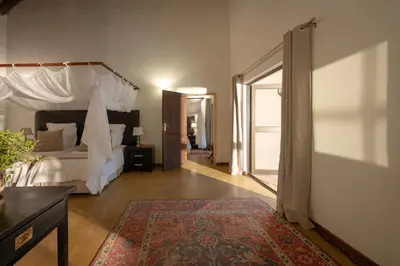 a bedroom with a bed with a canopy at Karongwe- Shiduli Safari Lodge in Hoedspruit
