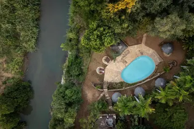 an overhead view of a swimming pool next to a river at Karongwe - Chisomo Safari Camp in Hoedspruit