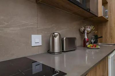 a kitchen with a counter with a silver appliance on it at StayCeity at Menlyn Maine in Pretoria