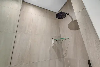 a shower with a shower head in a bathroom at StayCeity at Menlyn Maine in Pretoria